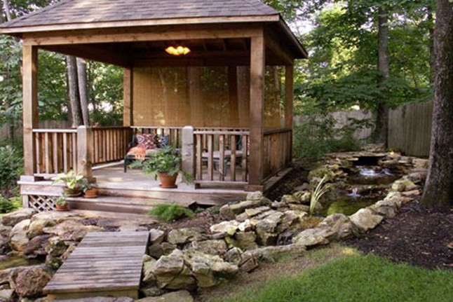 A stone dry creek bed is used here to divert water to the desired location.