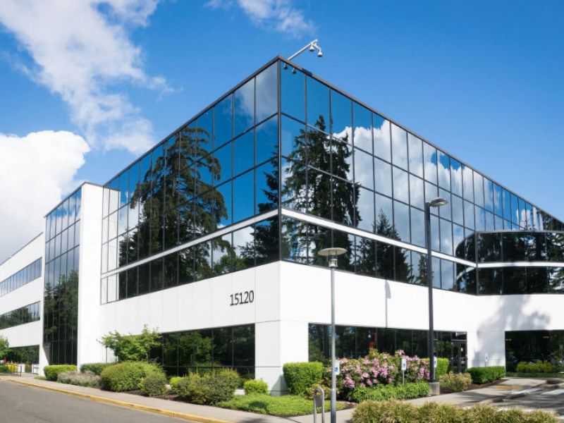 A commercial office building with well maintained landscaping.