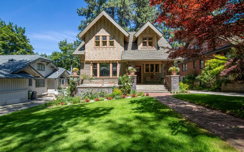A home with lush green turf grass and trees.